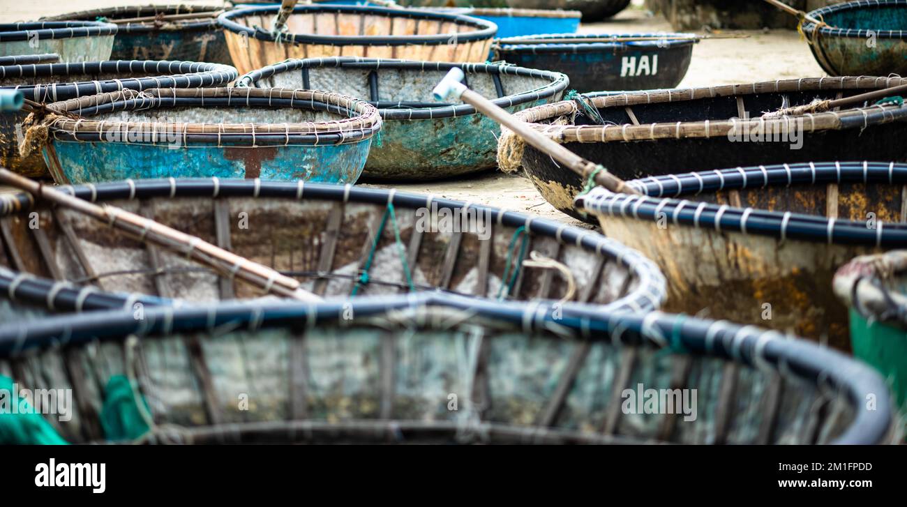 Traditional coracles used for fishing stored on My Khe beach in Danang, Vietnam. Stock Photo