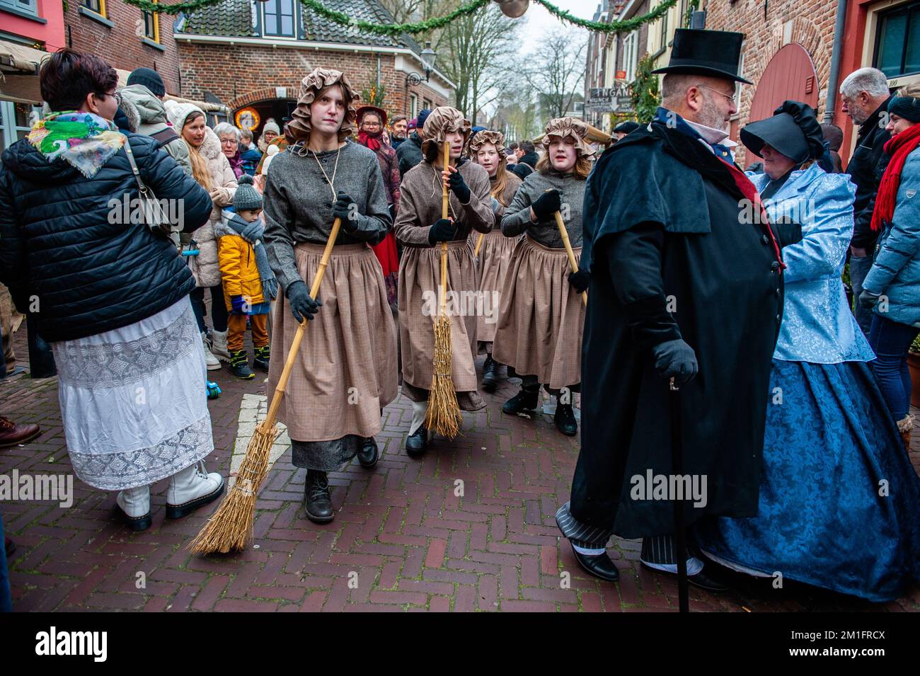 December 10th, Deventer. Each year, around this date, the 19th-century world of the English writer Charles Dickens relives in the beautiful Dutch city of Deventer. More than 950 characters from the famous books of Dickens revive Oliver Twist, Scrooge, Marley and Mr. Pickwick, etc. Wealthy ladies and gentlemen with top hats parade in the streets. The scenery of the festival consists of historical buildings and houses, Christmas trees, and thousands of little lights. Not only in the street, but also behind the windows, in the houses, and in the little shops and galleries. Stock Photo