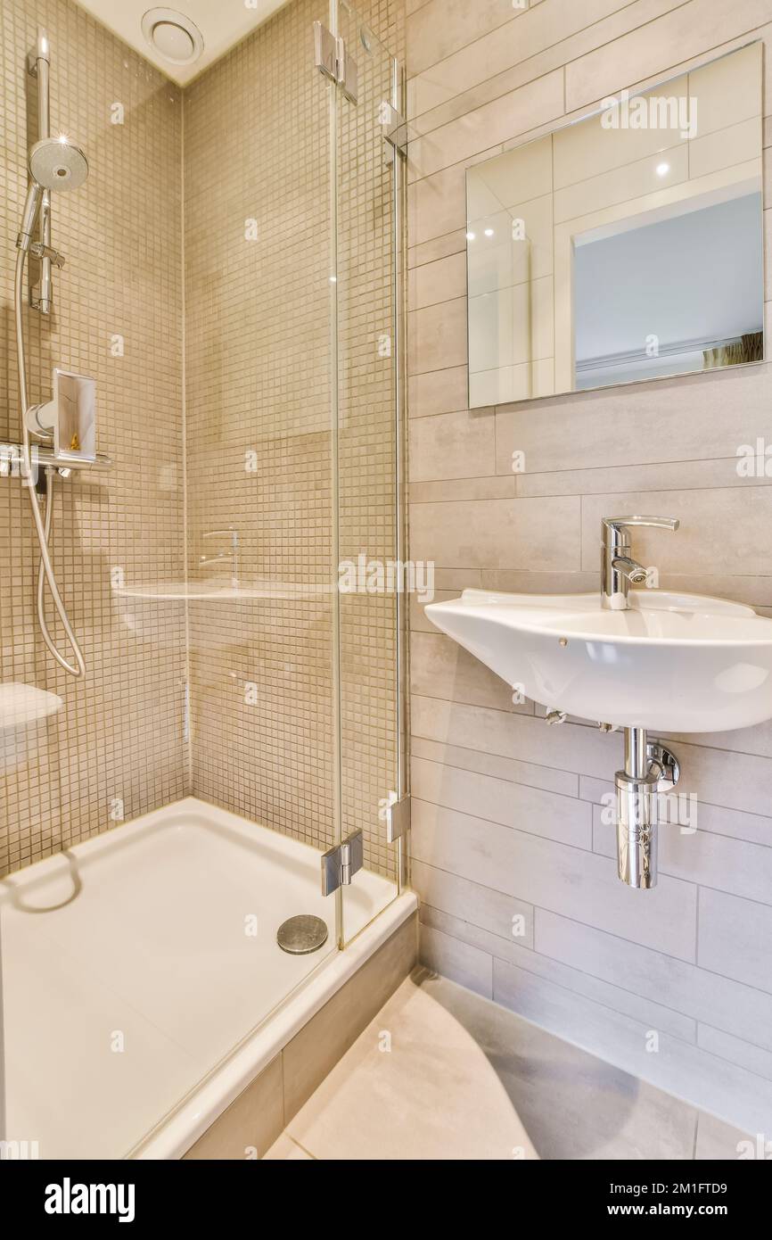 a bathroom with a sink, mirror and bathtub on the wall in this photo is ...