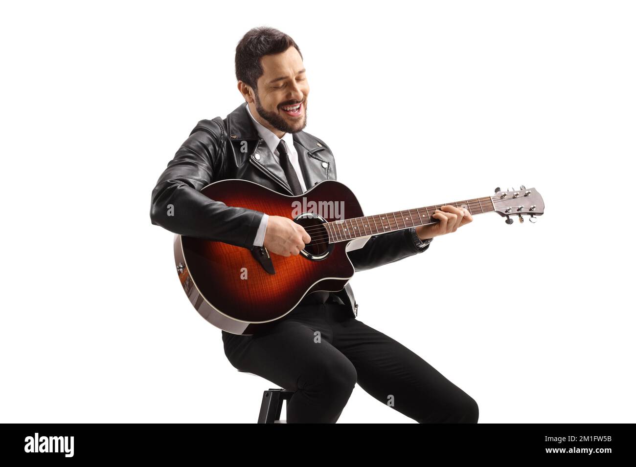 Male musician playing an acoustic guitar searted on a chair isolated on ...