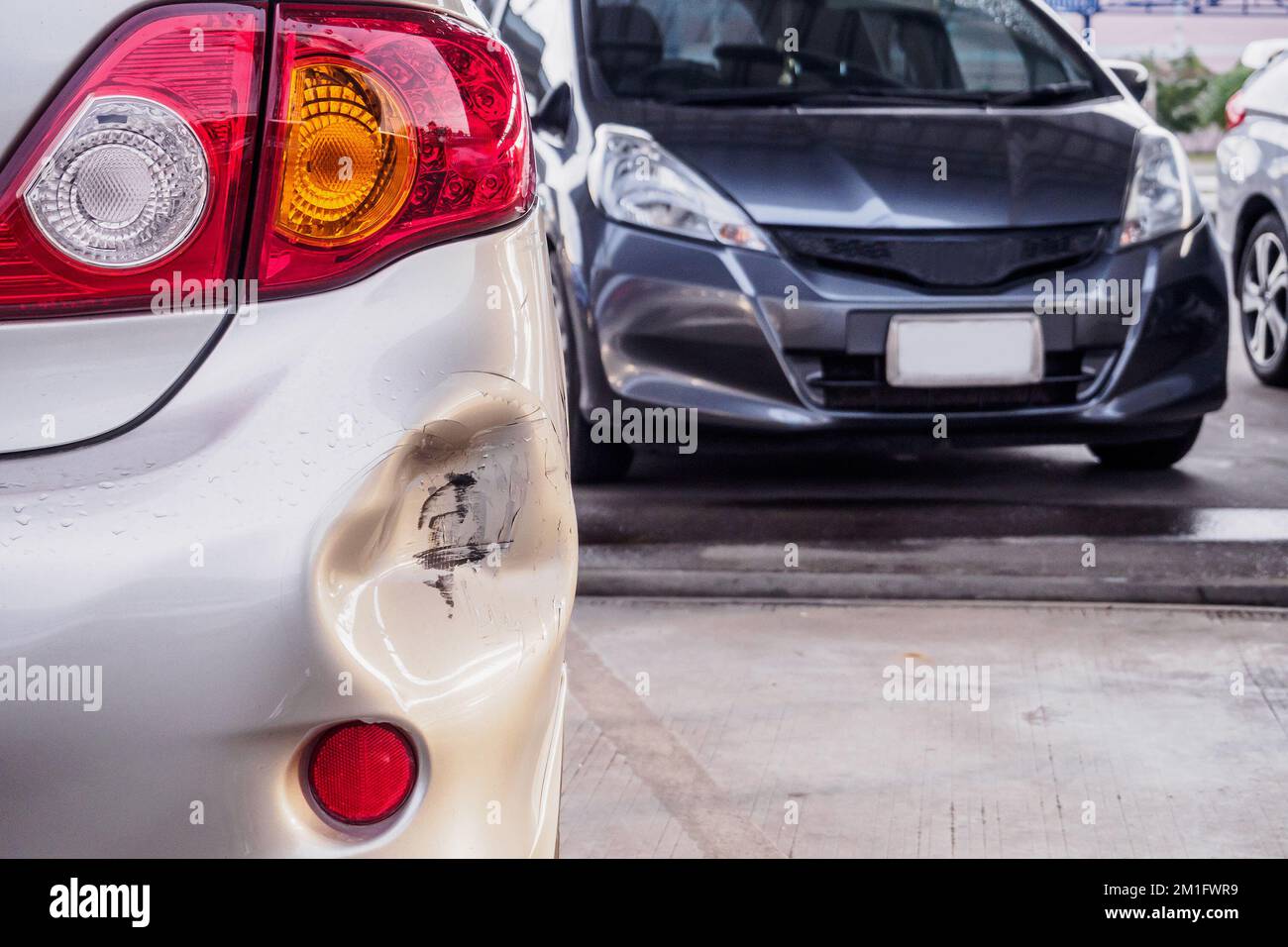 car has dented rear bumper damaged after accident Stock Photo