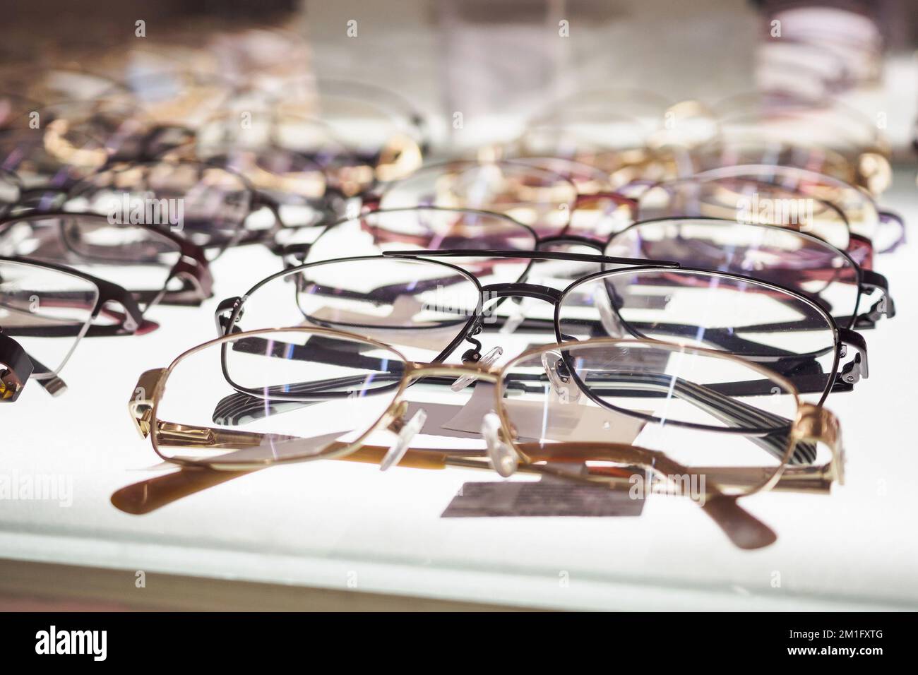 Eye glasses on window display shelves in optics store Stock Photo Alamy