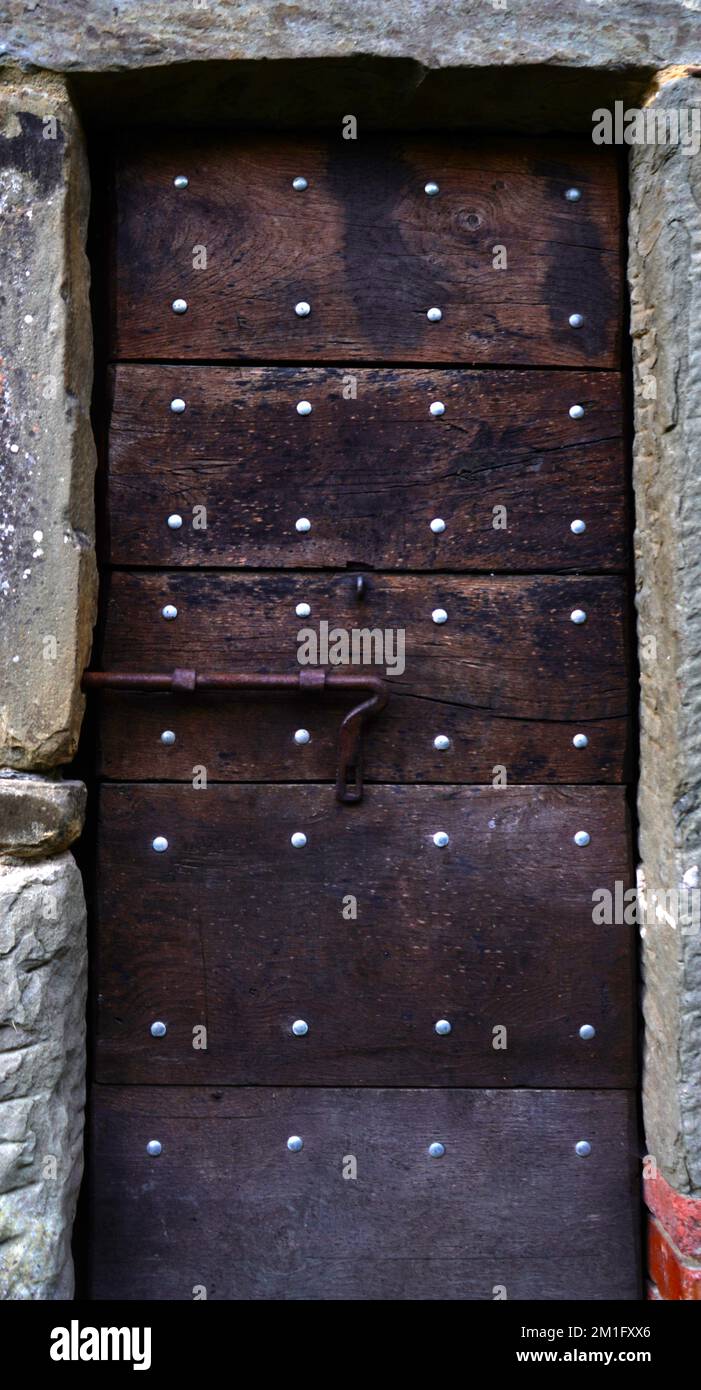 Old wooden entrance door in old rural italian stone house Stock Photo ...