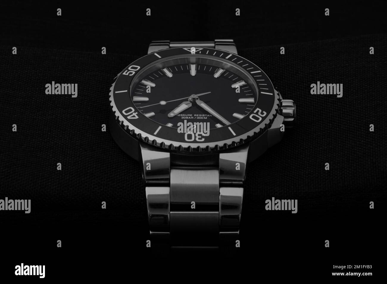 A Swiss made diver watch with steel bracelet, screw down crown, ceramic bezel, saphire glass