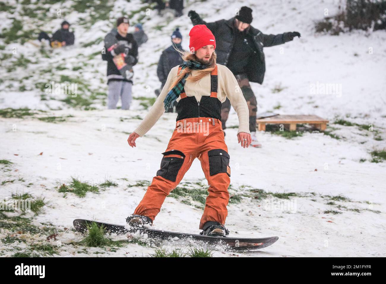 London, UK. 12th Dec, 2022. People in Greenwich Park have fun in the snow with the many snow covered hills of the Royal Park providing ample place for walkers and those who want to sledge, go tobogganing, and even snowboard. Credit: Imageplotter/Alamy Live News Stock Photo