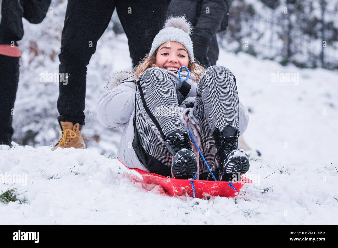 London, UK. 12th Dec, 2022. People in Greenwich Park have fun in the snow with the many snow covered hills of the Royal Park providing ample place for walkers and those who want to sledge, go tobogganing, and even snowboard. Credit: Imageplotter/Alamy Live News Stock Photo