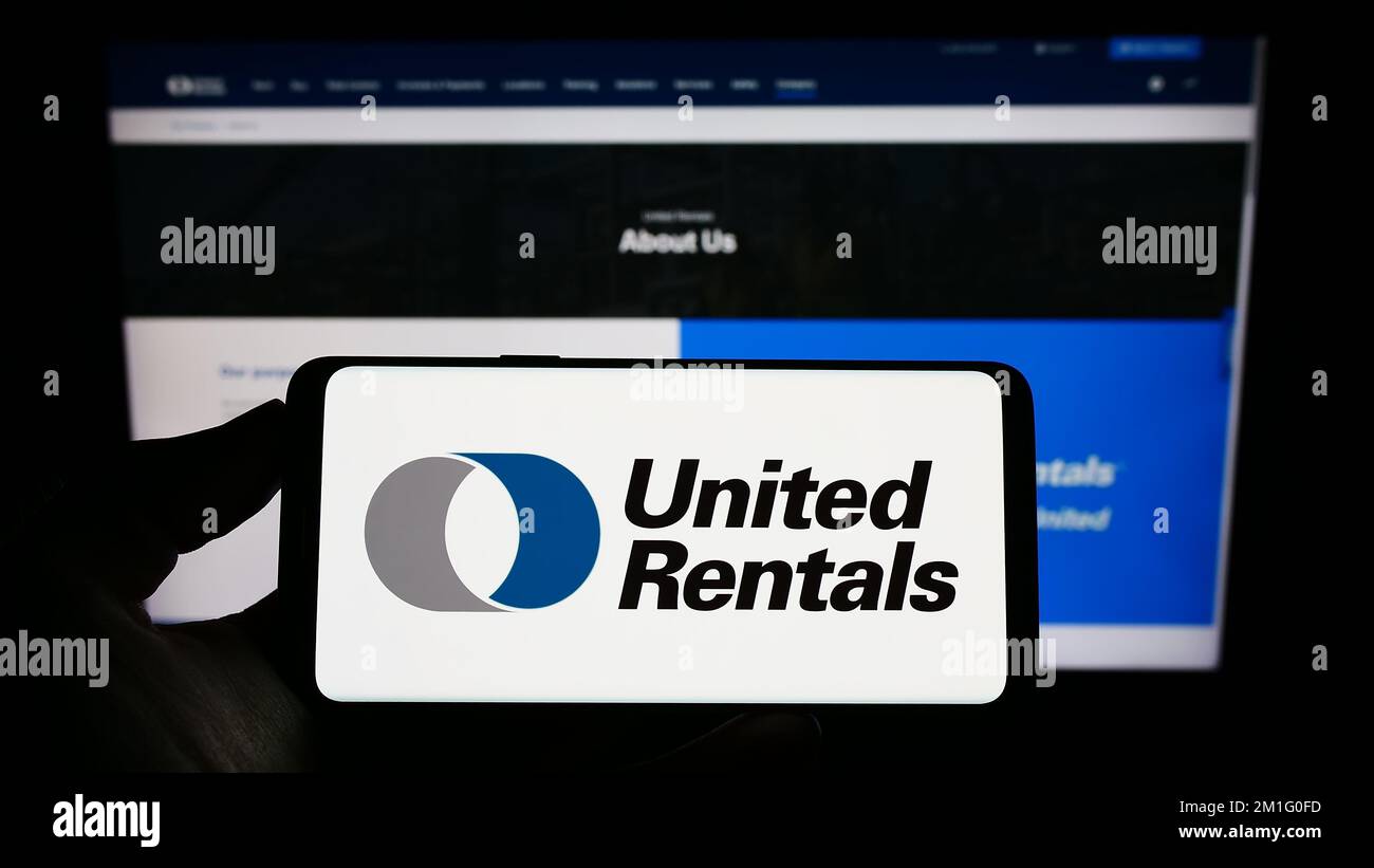 Person holding smartphone with logo of US equipment rental company