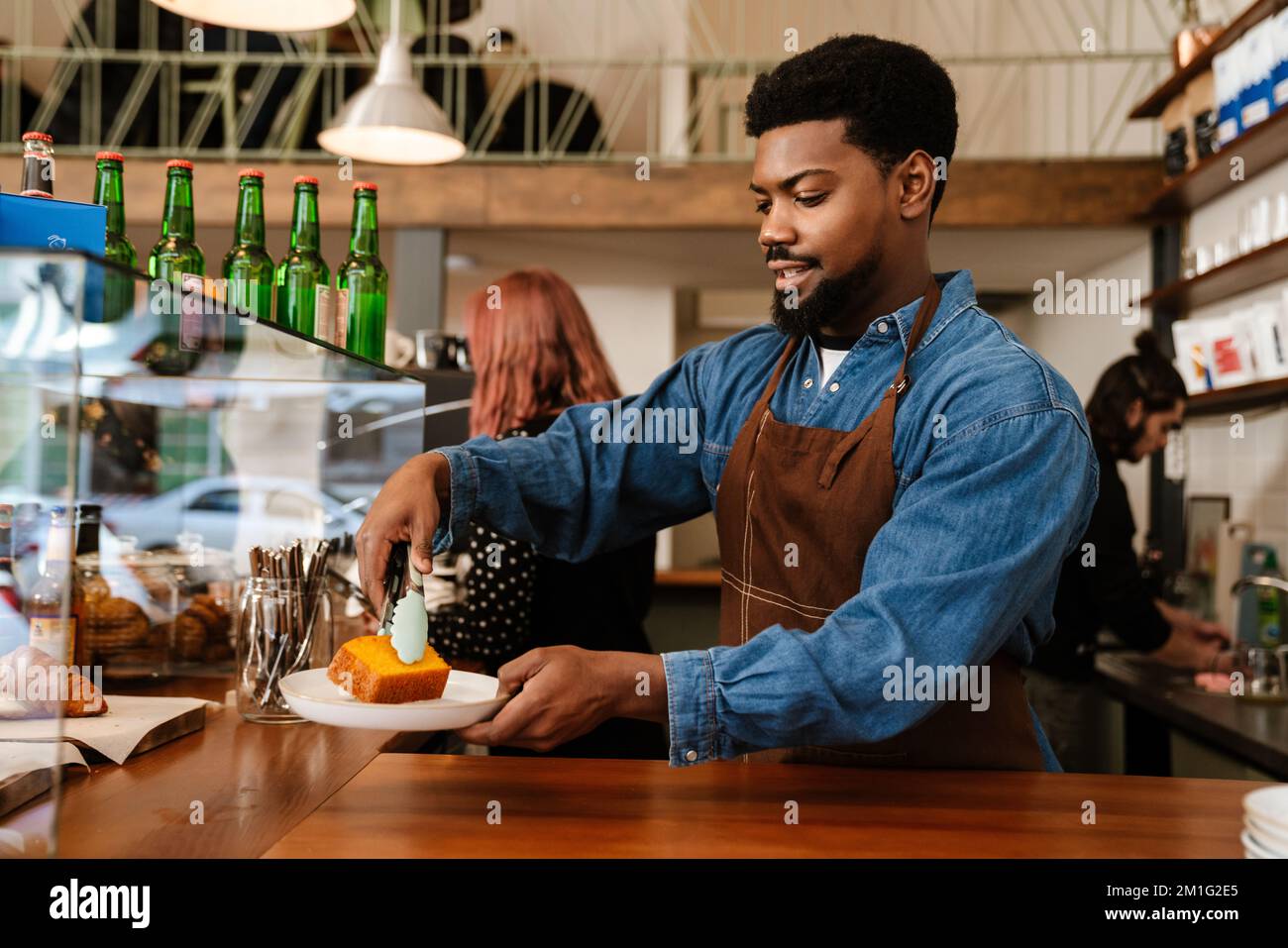 Woman barista wearing denim apron hi-res stock photography and images ...