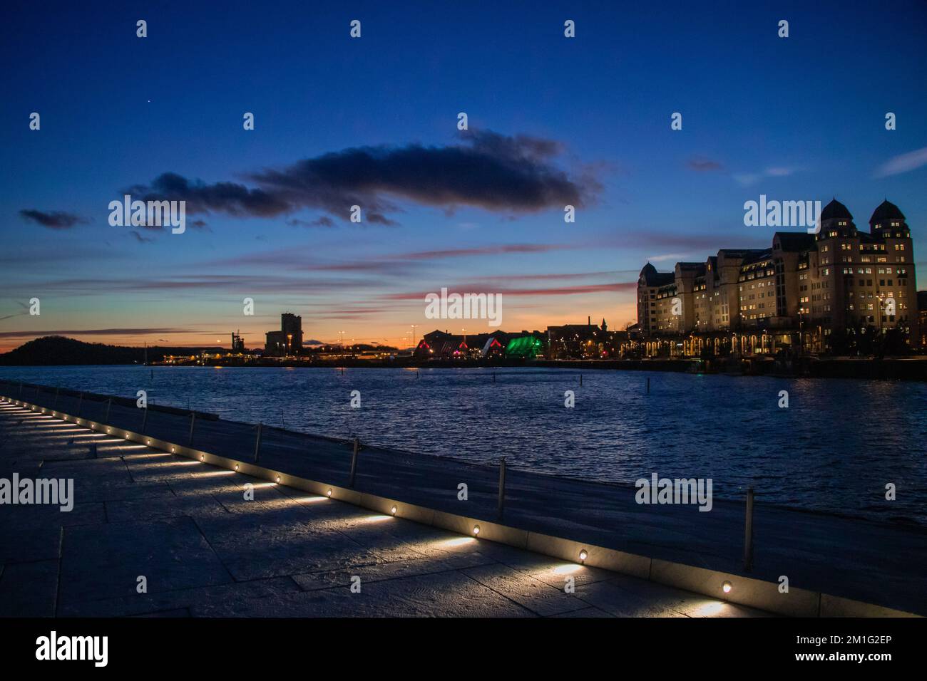 City of Oslo Norway in the Evening with Sunset, Sea, Historical buildings and Christmas decorations Stock Photo