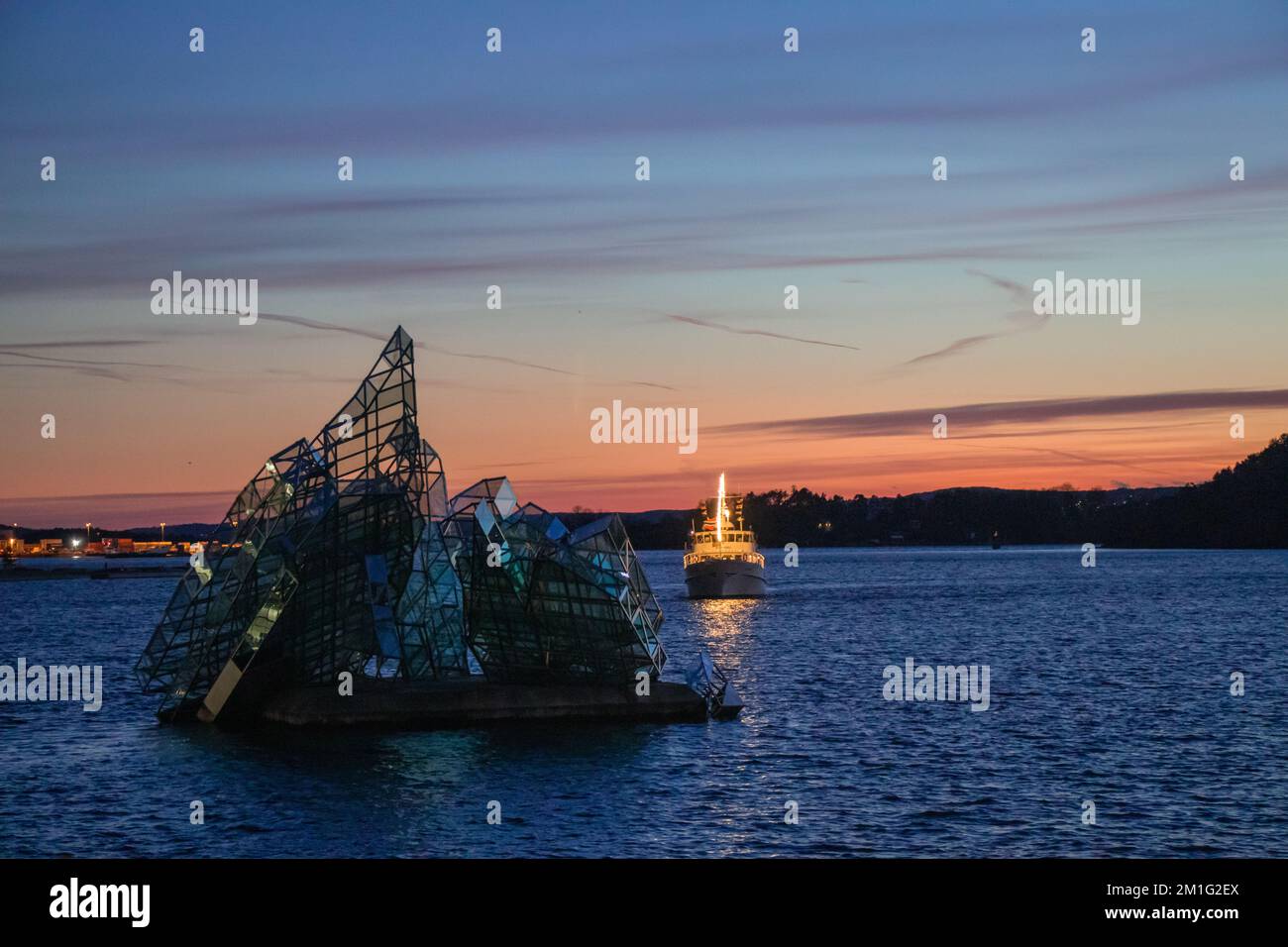 City of Oslo Norway in the Evening with Sunset, Sea, Historical buildings and Christmas decorations Stock Photo