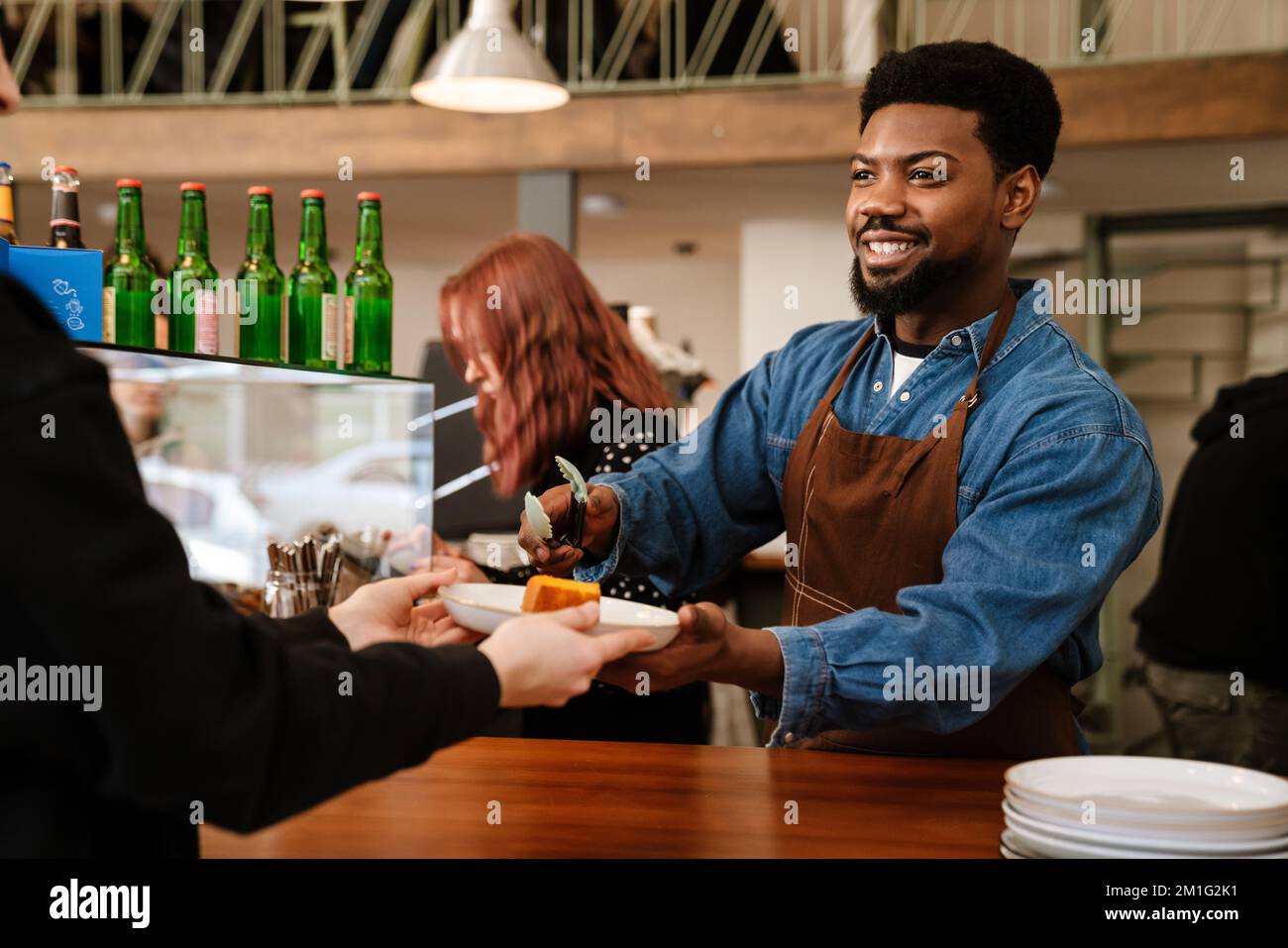 Woman barista wearing denim apron hi-res stock photography and images ...