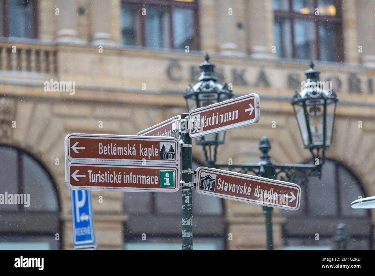 PRAGUE, Czech Republic – DECEMBER 12th 2022: Informational signs, street guide board with famous Czech places, snowy winter Stock Photo