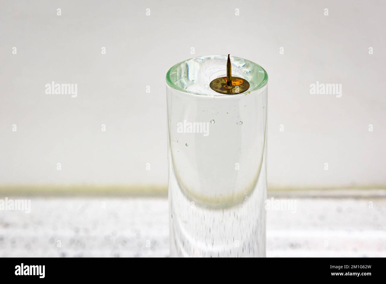 A metal pin floats on water due to the surface tension caused by the