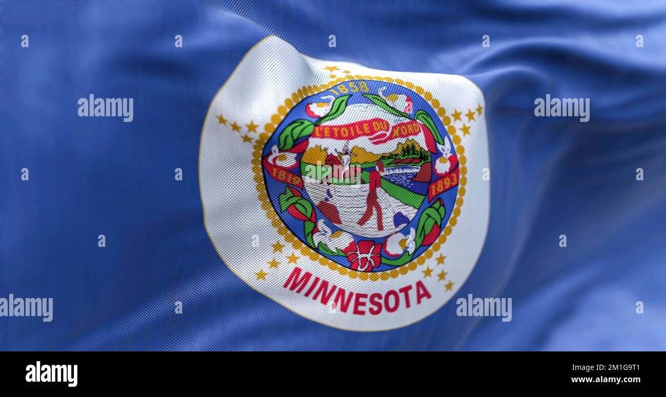 The US state flag of Minnesota waving in the wind. Minnesotais a state in the upper midwestern region of the United States. Rippled textile background Stock Photo