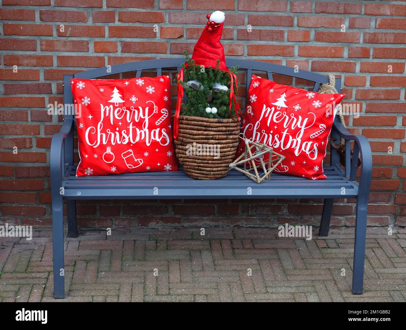 Blue bench with merry Christmas cushions on it Stock Photo Alamy