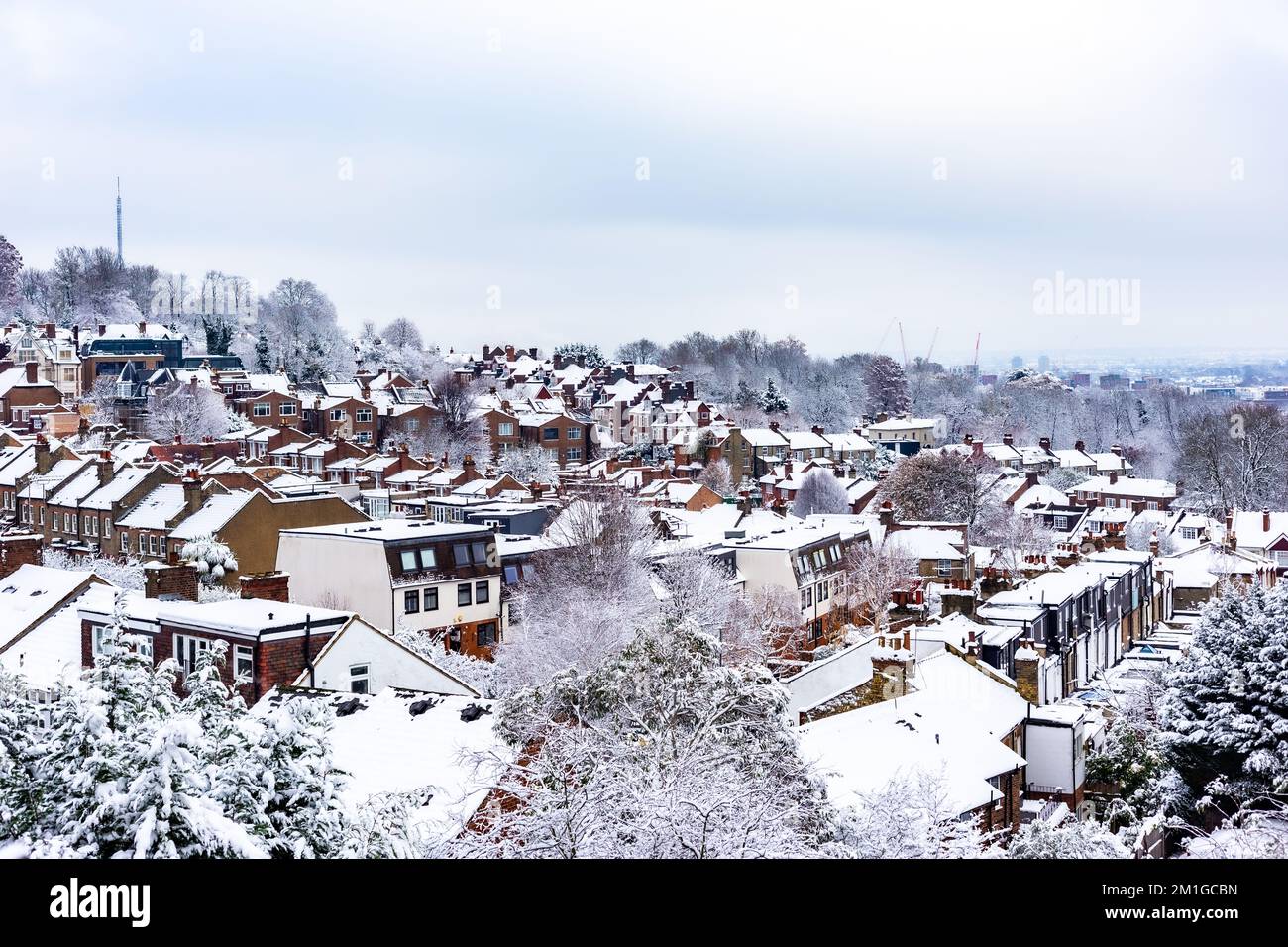 A high view point in North London is focused on heavy snow covered houses and apartments.Rows of terraced houses in all directions.Cold as ice ! Stock Photo