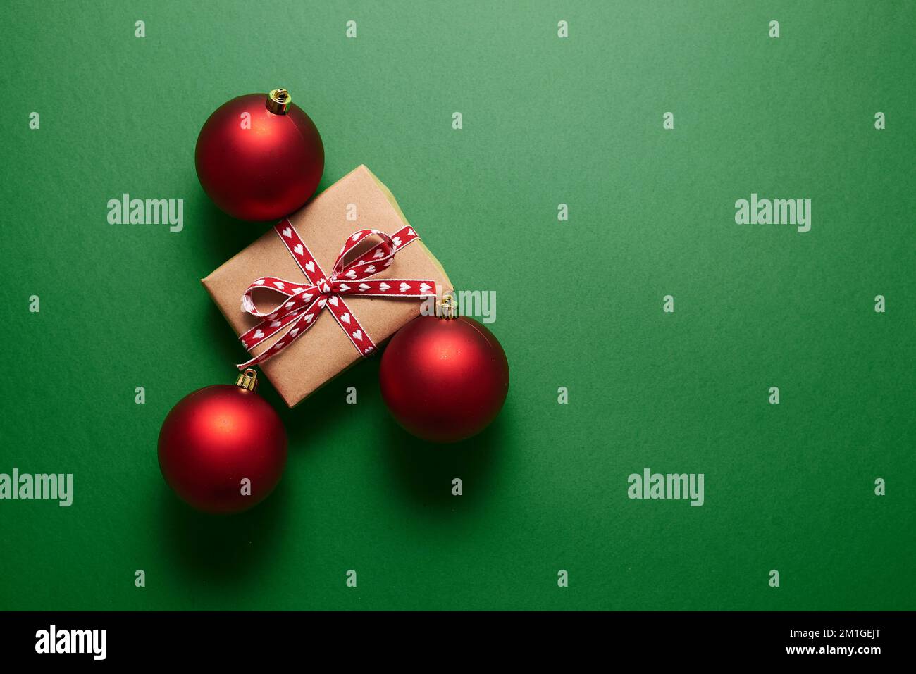 Christmas decoration and gift box on green background. Stock Photo