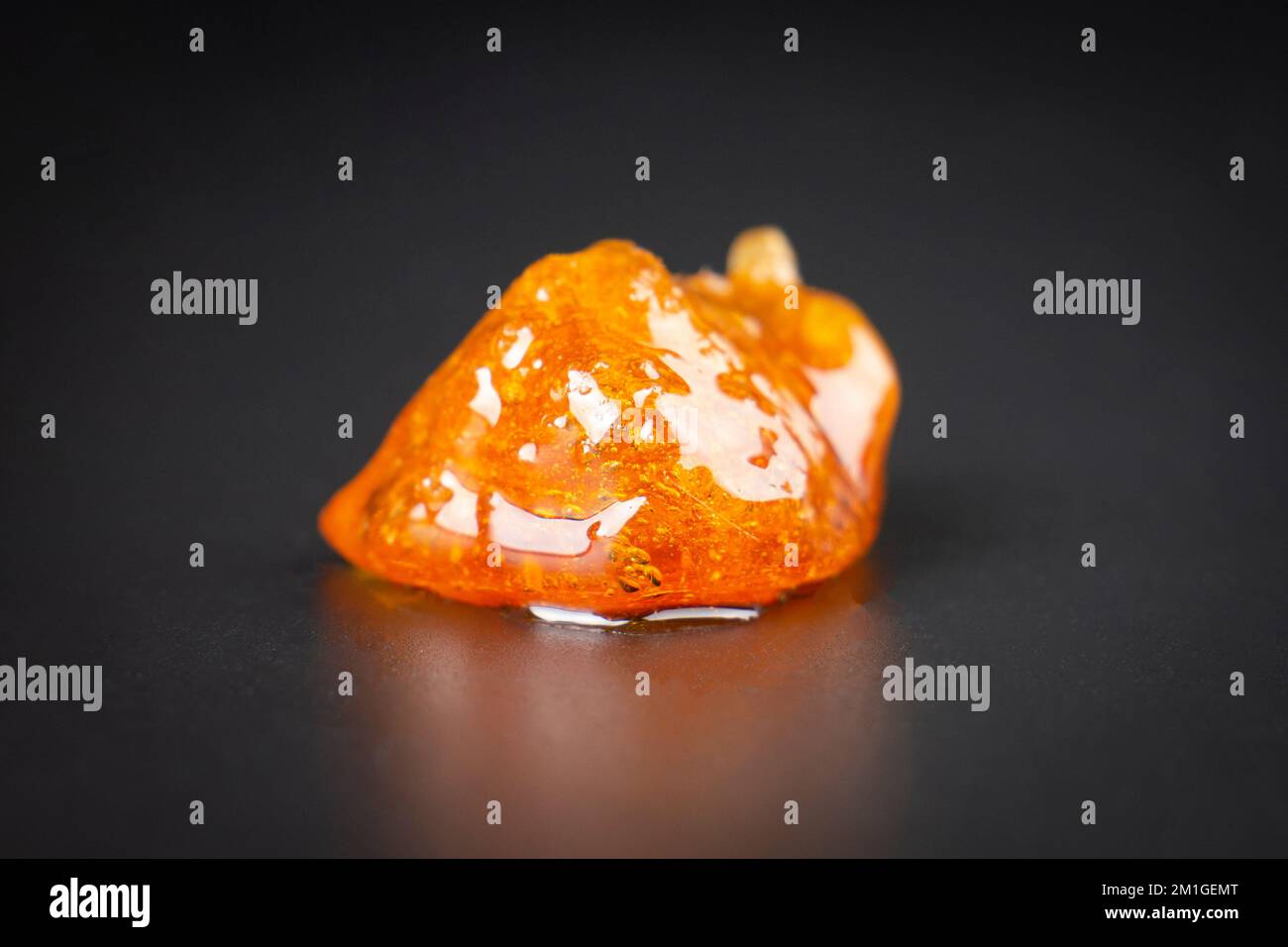 a pieces of cannabis wax closeup. concentrate dab stone with high thc