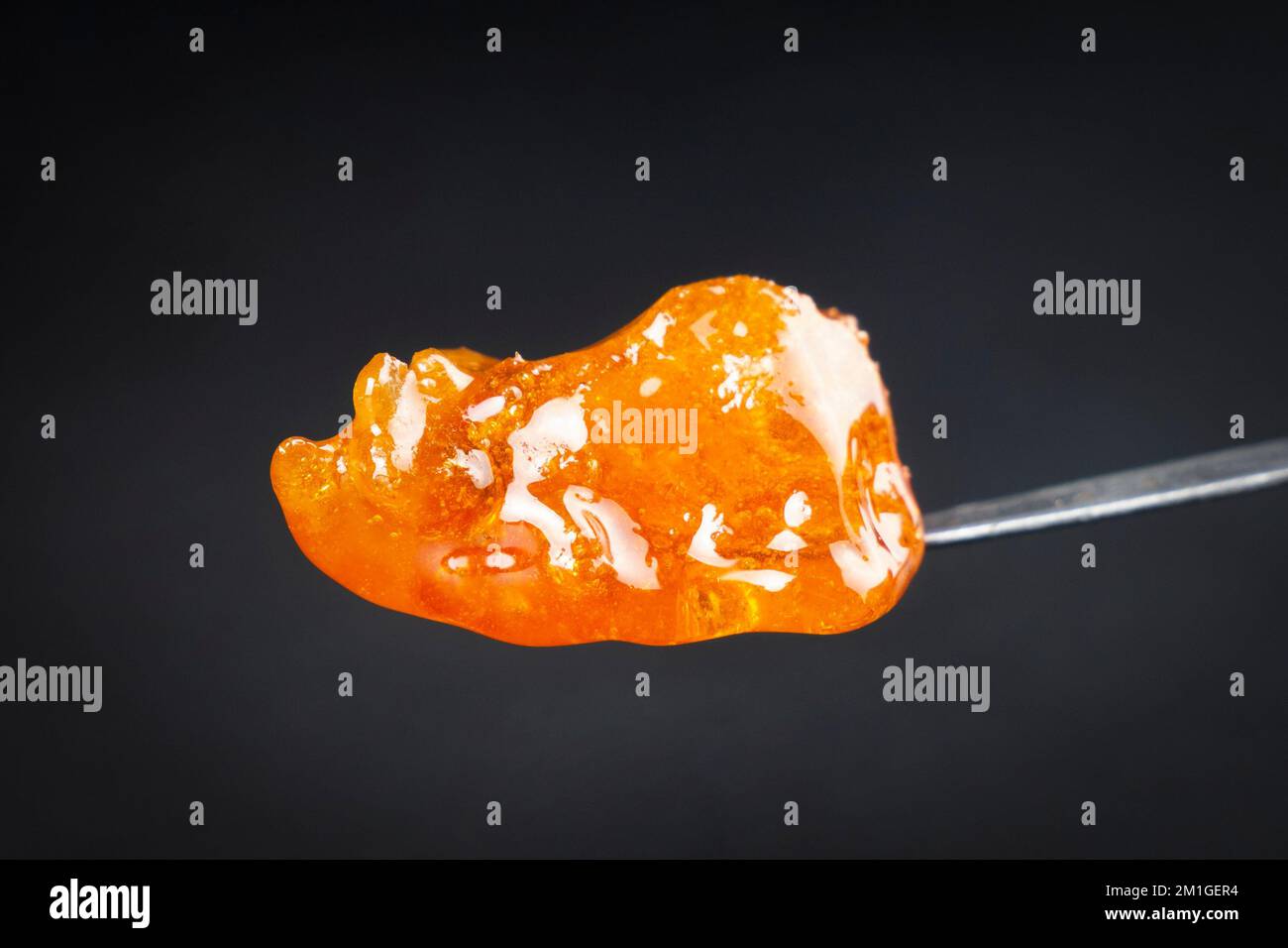 cannabis golden dab in dark, thc resin wax close up Stock Photo Alamy