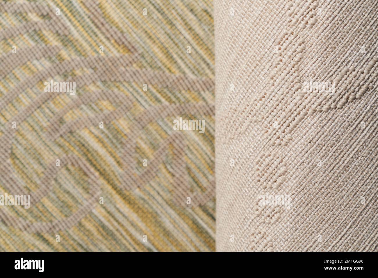 Front and back side of multi-colored rug with embossed pattern , which is canvas with white base and vertical cotton rows of beige color. Close up of textile background for design. Textures concept. Stock Photo