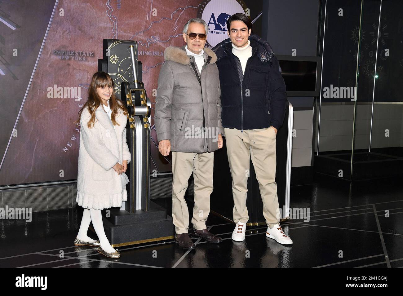 New York, USA. 12th Dec, 2022. Italian tenor Andrea Bocelli (c), and his children Matteo Bocelli (r) and Virginia Bocelli (l) participate in the ceremonial lighting of the Empire State Building in honor of the Andrea Bocelli Foundation's 'Voices of' charity, New York, NY, December 12, 2022. (Photo by Anthony Behar/Sipa USA) Credit: Sipa USA/Alamy Live News Stock Photo