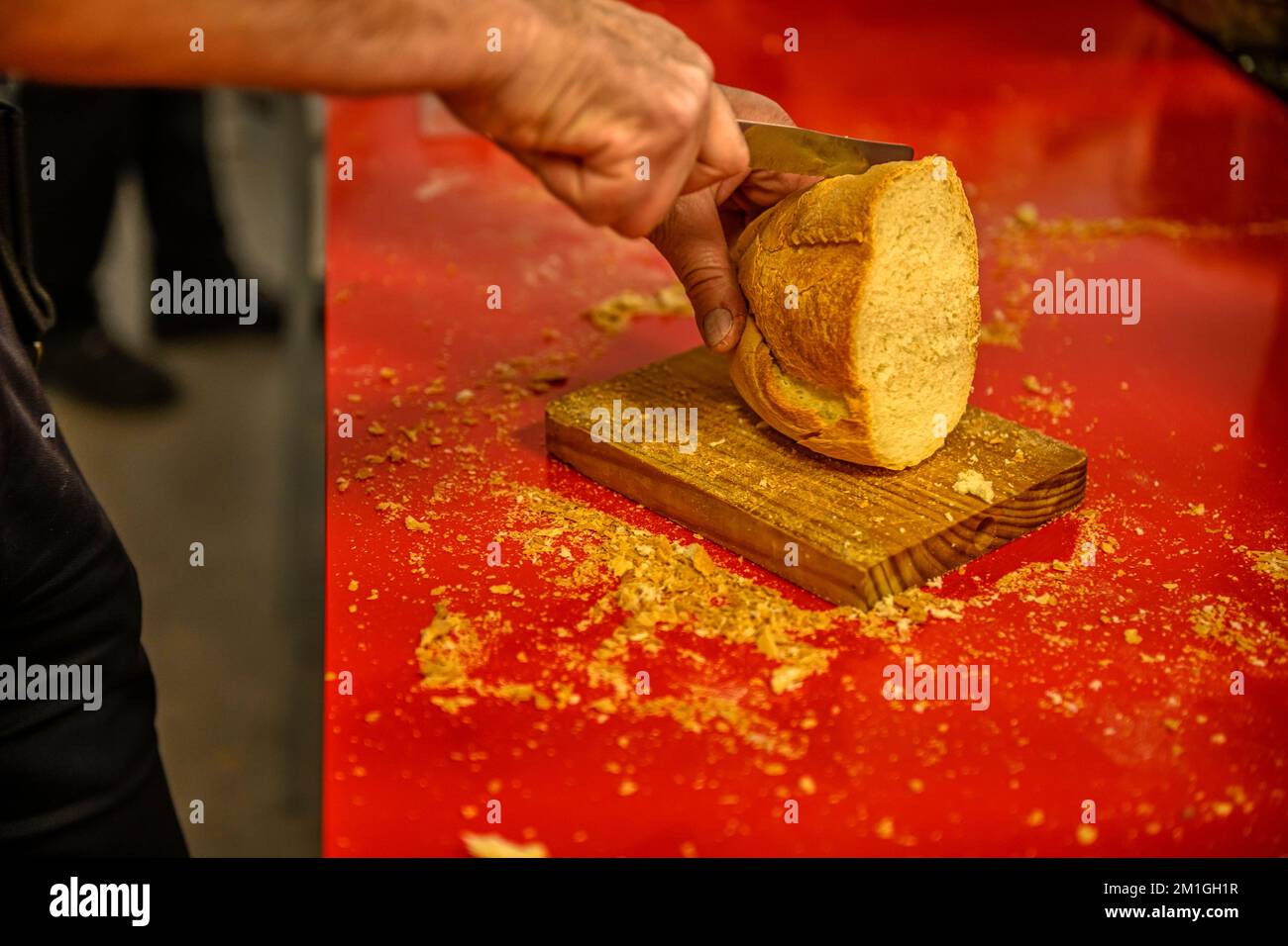 Cut a loaf of bread into smaller portions Stock Photo