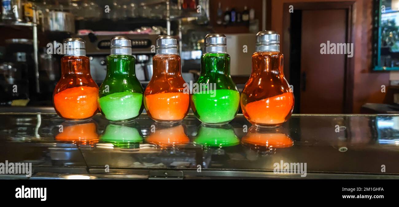 Salt cellars lined up in the display of a bar Stock Photo Alamy