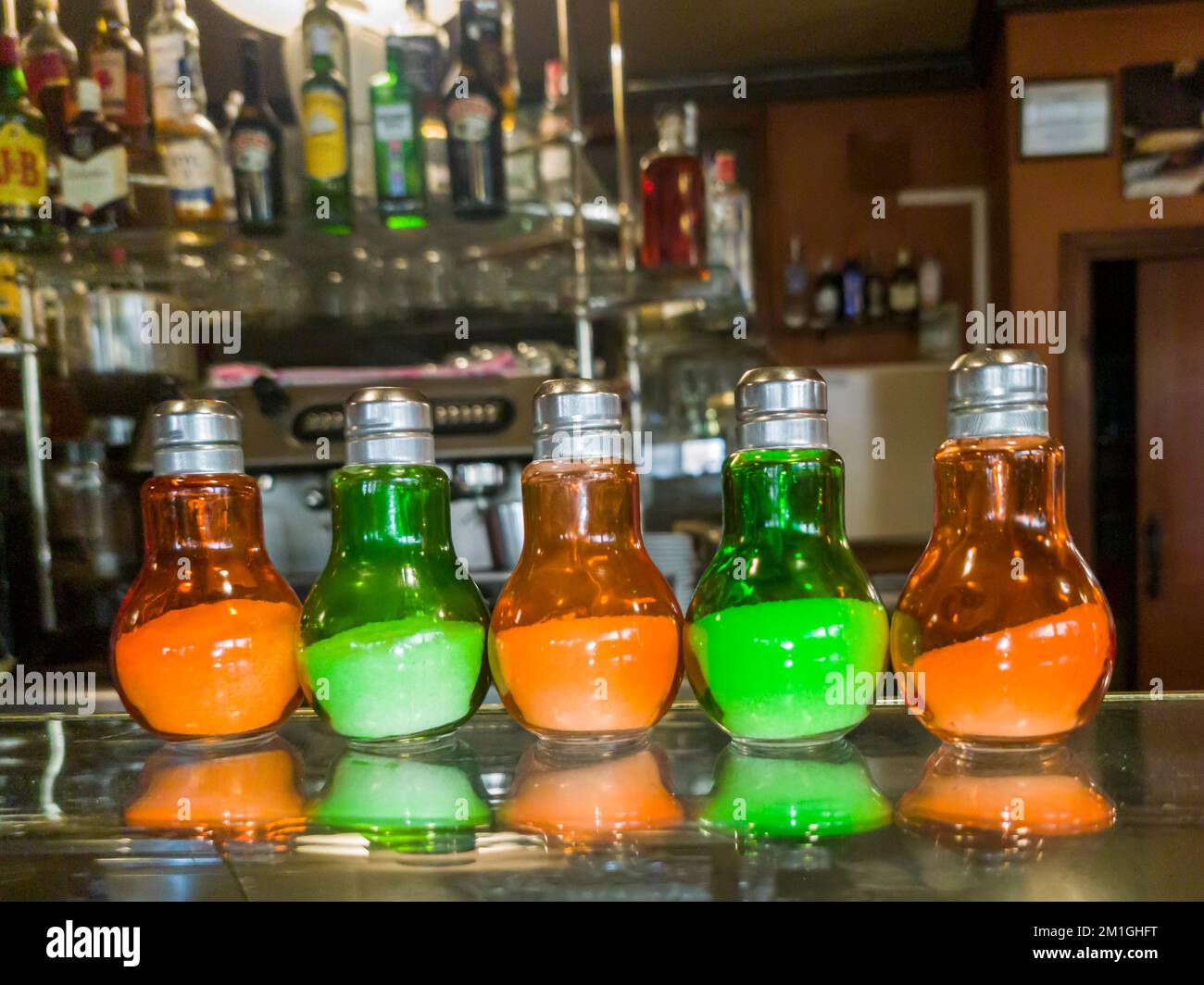 Salt cellars lined up in the display of a bar Stock Photo Alamy