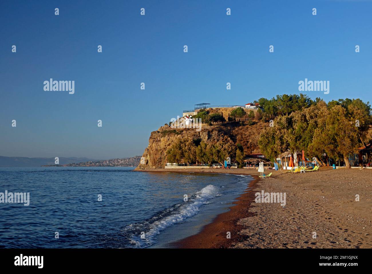 Anaxos Beach, Lesbos with Anaxos Hill and headland with decorative windmill.. September / October 2022. Stock Photo