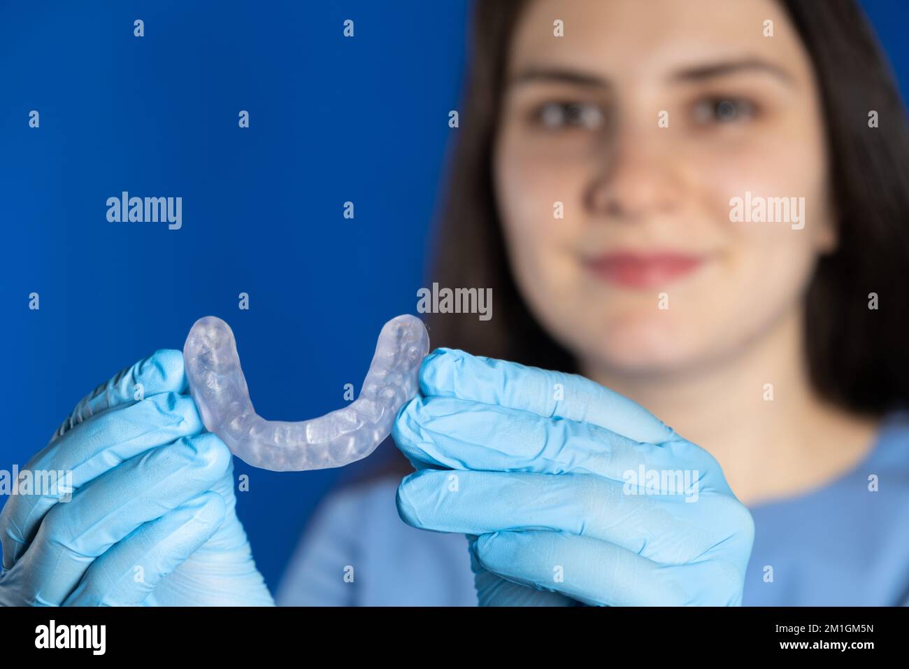 Doctor holding dental mouthguard, splint for the treatment of