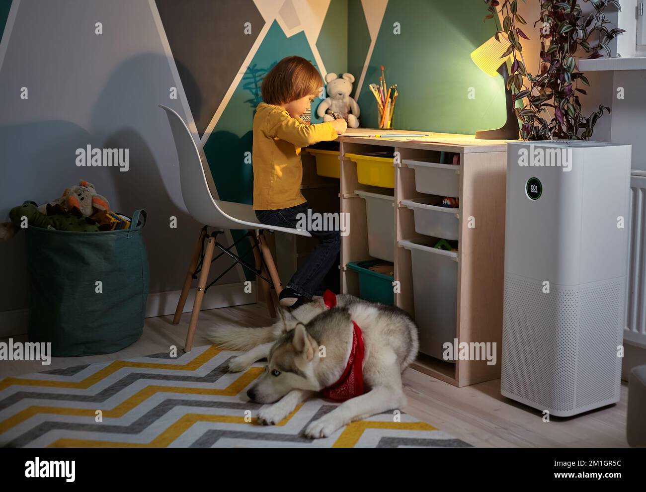Air purifier in the children's room with an allergy child and a dog Stock Photo