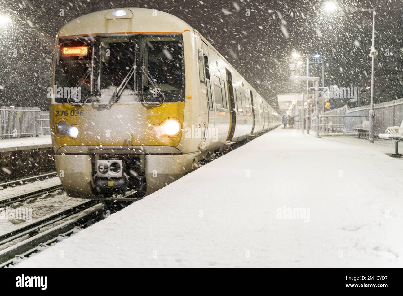 Southeastern train pulling in  station platform when Artic freeze brought heavy snow falls in Greenwich, South East London England Stock Photo