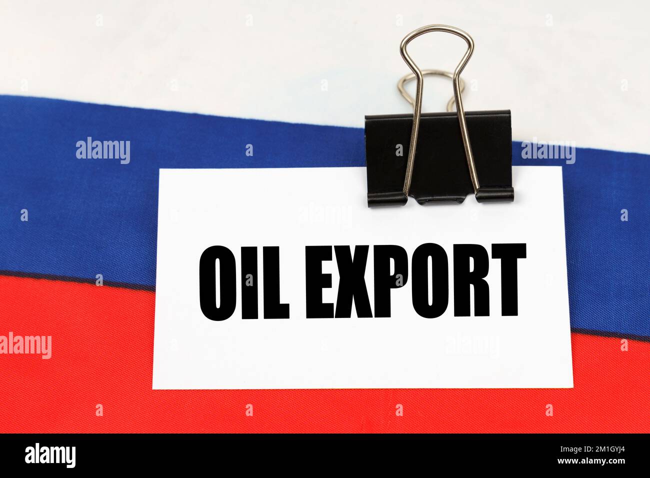 National concept. On the flag of Russia there is a business card with the inscription - Oil export Stock Photo