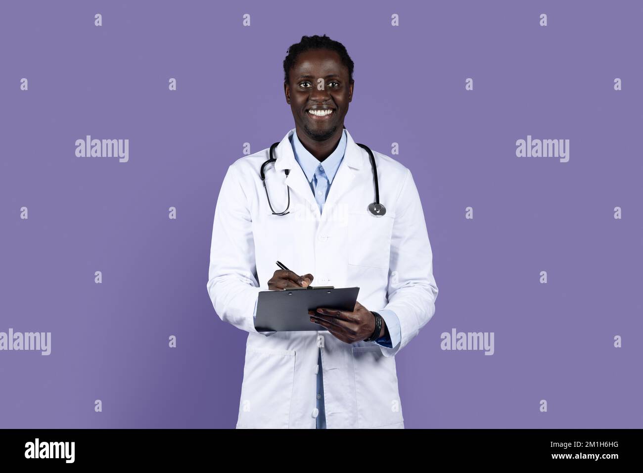 Portrait of friendly young black doctor with medical chart Stock Photo