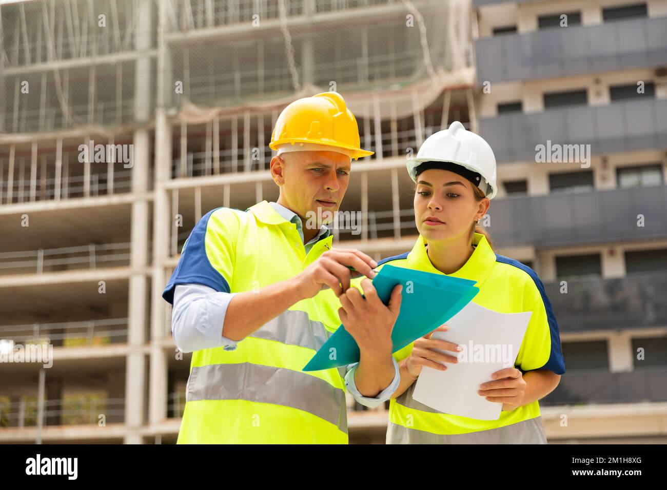 Two qualified engineers are discussing a construction plan Stock Photo