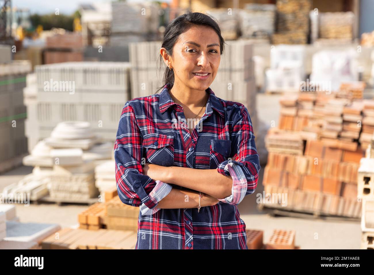 Woman worker posing at building materials warehouse Stock Photo