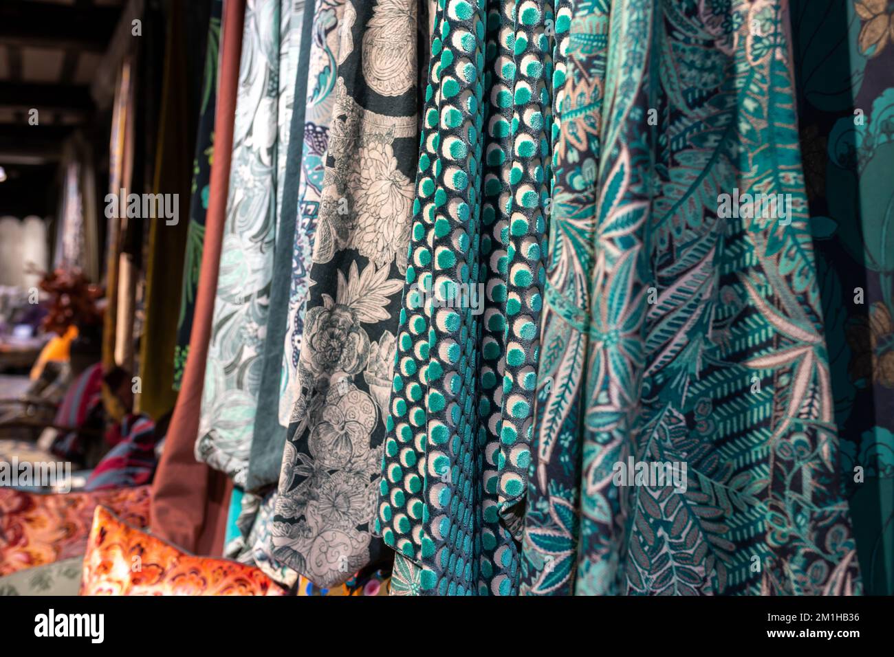 Various wool and silk fabrics are on display at the shop Stock Photo