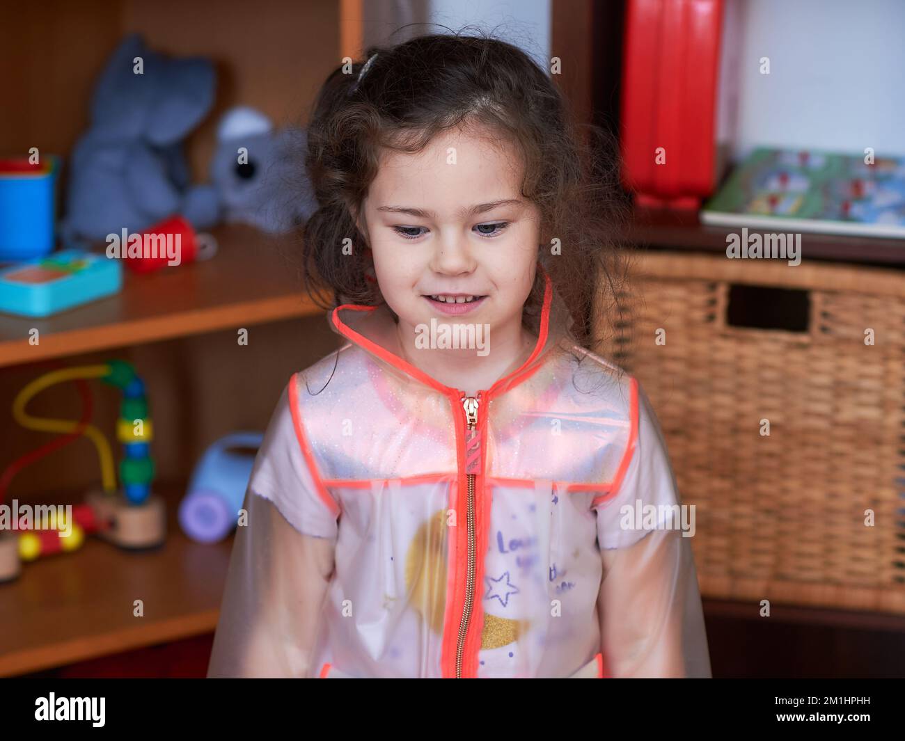 cute girl posing in a rain cover in her room Stock Photo Alamy