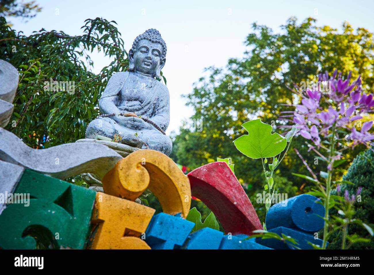 Colorful lettering and small stone Buddha statue at Tibetan Mongolian