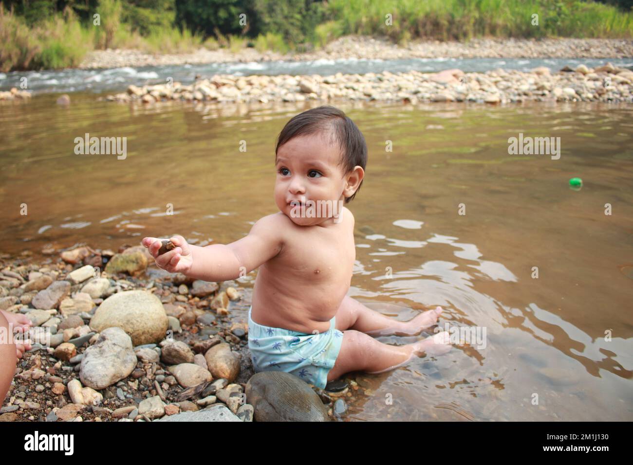 Niño feliz en un rio de Peru Stock Photo