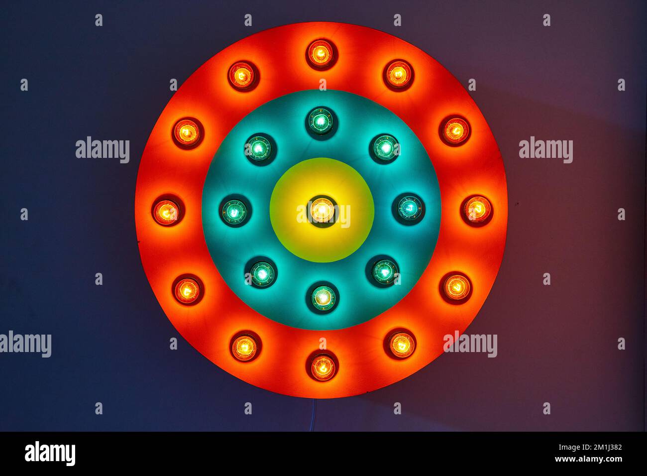 Circle red, blue, and yellow neon light on wall Stock Photo