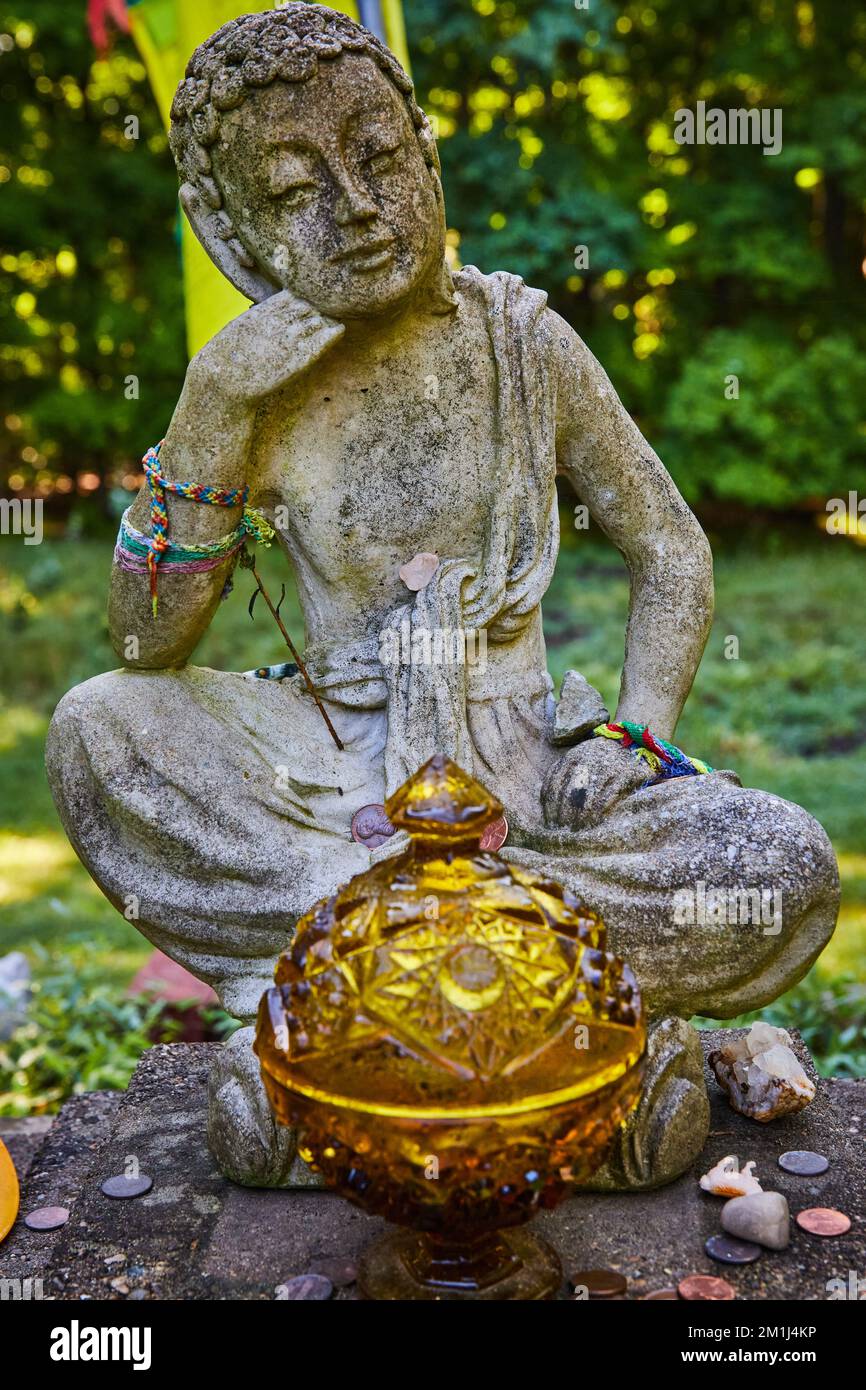Detail of stone Tibetan Mongolian Buddhist statue surrounded by natural ...