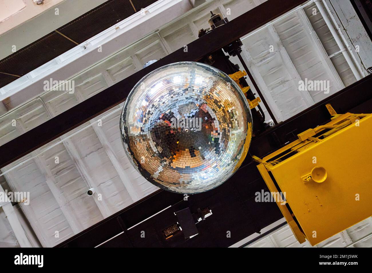 Huge disco ball hanging from ceiling in old building Stock Photo Alamy