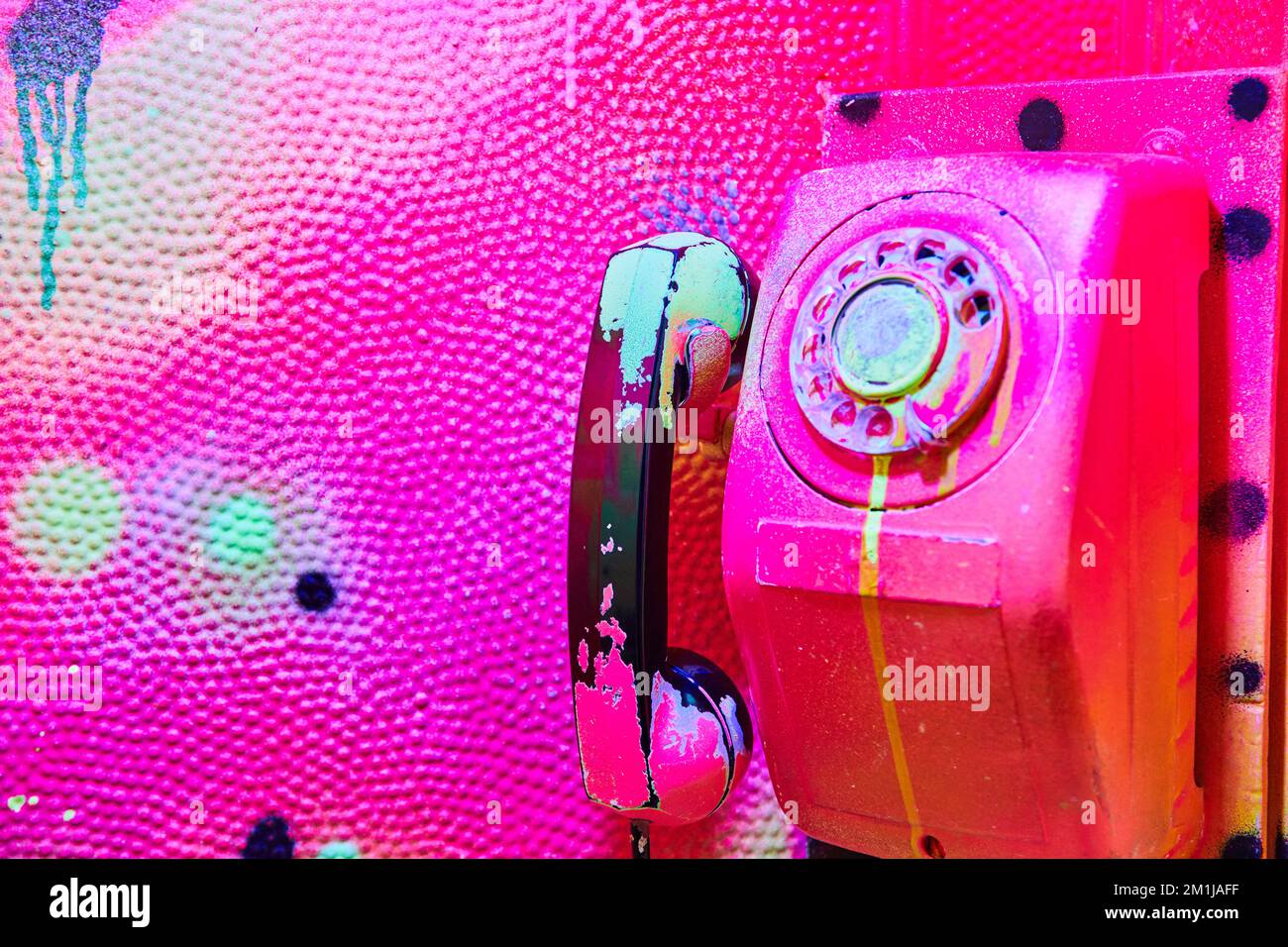 Graffiti pink painted fully over old telephone booth Stock Photo