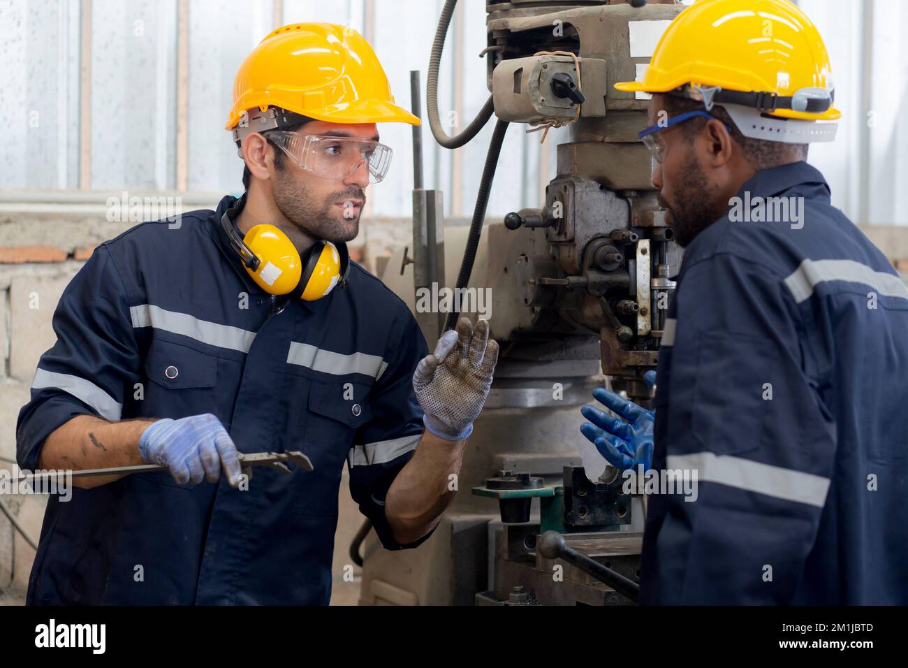 Engineer man training with foreman for apprentice using lathe, apprenticeship teaching with worker, technician and learning, inspector and labor, inte Stock Photo