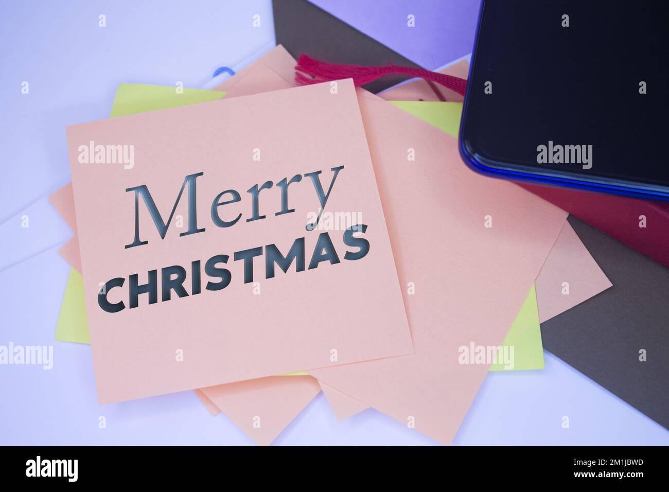 Merry Christmas. Text on adhesive note paper. Event, celebration reminder message. Stock Photo