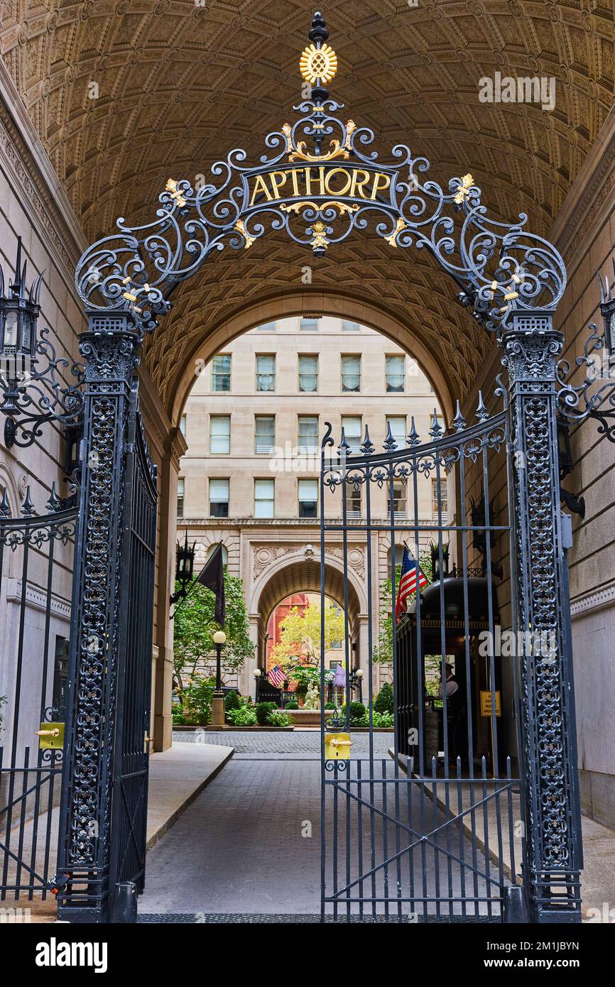 Black steel gates in New York City archway lead into beautiful private