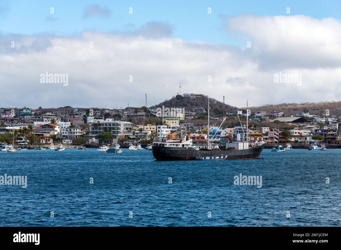 Harbour with ships and cityscape of Puerto Baquerizo Moreno, Galapagos national park, Ecuador. Stock Photo