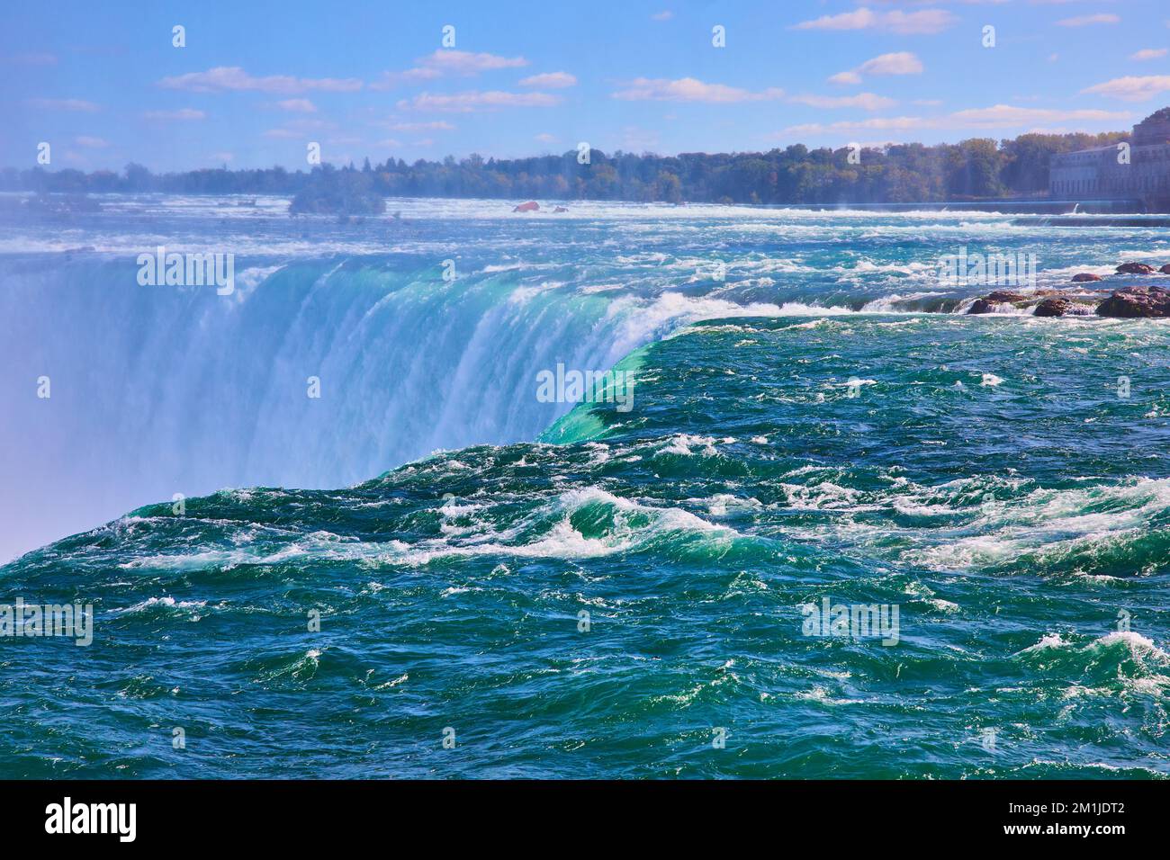 Right on edge of Niagara Fall's Horseshoe Falls with turquoise waters in Canada Stock Photo