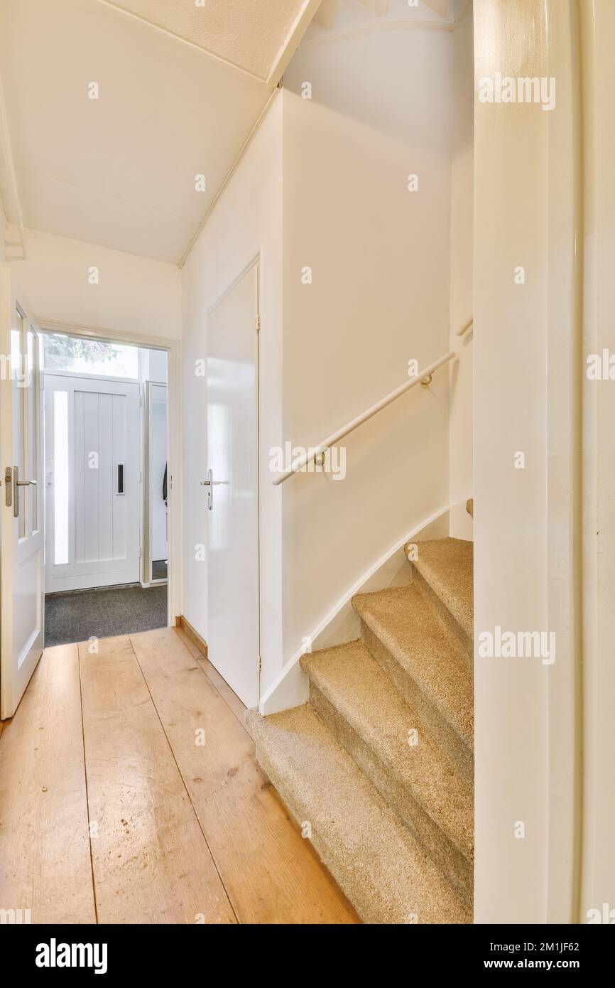 Curated visual reference: Picture Idea: White Hallway With Wooden Stairway Leading To Second Floor Of